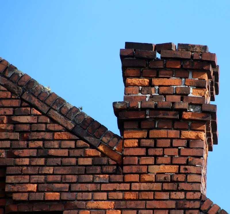 Signs Your Ann Arbor Home Needs a Chimney Inspection Damaged chimney on an Ann Arbor home showing cracks and missing mortar